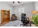 Inviting home office with a wooden bookshelf, leather chair, and stylish desk at 933 Jackline Place # 101, Murrells Inlet, SC 29576