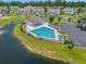 Aerial view of the community pool, featuring ample seating, parking and a serene lakeside backdrop at 933 Jackline Place # 101, Murrells Inlet, SC 29576