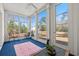 Bright sunroom with large windows offering picturesque outdoor views and a comfortable seating area at 933 Jackline Place # 101, Murrells Inlet, SC 29576