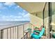Balcony view with table and chairs offering stunning oceanfront beach views with railing at 9400 Shore Dr. # 722, Myrtle Beach, SC 29572