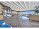 Bright indoor pool area with lounge chairs, tables and large windows at 9400 Shore Dr. # 722, Myrtle Beach, SC 29572