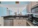 Open kitchen with stainless steel appliances, granite countertops, and breakfast bar overlooking the living room at 9400 Shore Dr. # 722, Myrtle Beach, SC 29572