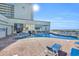 Inviting outdoor pool area with brick pavers and plenty of lounge chairs for relaxation at 9400 Shore Dr. # 722, Myrtle Beach, SC 29572