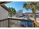 Wood balcony with view of palm trees and a brick building at 10200 Lake Shore Dr. # 16, Myrtle Beach, SC 29572