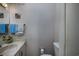 Well-maintained bathroom with a marble-look sink, toilet, and decorative wallpaper at 10200 Lake Shore Dr. # 16, Myrtle Beach, SC 29572