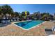 Community pool surrounded by palm trees, lounge chairs, and well-maintained landscaping at 10200 Lake Shore Dr. # 16, Myrtle Beach, SC 29572