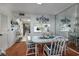 Bright dining area with a glass table, white chairs, and views into the kitchen at 10200 Lake Shore Dr. # 16, Myrtle Beach, SC 29572