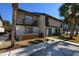 Two-story townhome featuring a balcony, lush landscaping, and sidewalk access at 10200 Lake Shore Dr. # 16, Myrtle Beach, SC 29572