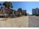 Two-story townhomes surrounded by palm trees, offering a serene beachside community at 10200 Lake Shore Dr. # 16, Myrtle Beach, SC 29572