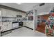 Functional kitchen with white cabinets, an oven and access to dining and living areas at 10200 Lake Shore Dr. # 16, Myrtle Beach, SC 29572