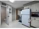 Cozy kitchen featuring white appliances, cabinets, and a sliding glass door to the outside at 10200 Lake Shore Dr. # 16, Myrtle Beach, SC 29572