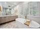 Bright bathroom with a marble floors, soaking tub and a modern vanity at 1046 Wallace Pate Dr., Georgetown, SC 29440