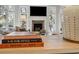 Cozy living room featuring a fireplace, large windows, and books on a table at 1046 Wallace Pate Dr., Georgetown, SC 29440