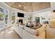 Bright and airy living room with a cozy fireplace, wood ceiling, and large windows overlooking the yard at 1046 Wallace Pate Dr., Georgetown, SC 29440