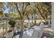 Scenic outdoor patio with lounge chairs and lush greenery overlooking a tranquil lake and golf course at 1046 Wallace Pate Dr., Georgetown, SC 29440