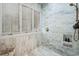 Close-up of the marble shower with windows and brushed gold fixtures at 1046 Wallace Pate Dr., Georgetown, SC 29440