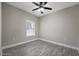 This bedroom has modern flooring, a ceiling fan, and a window providing natural light at 1107 Haden Place, Calabash, NC 28467