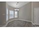 Bright dining room with stylish chandelier, wood-look flooring, and large windows at 1107 Haden Place, Calabash, NC 28467