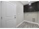 Functional laundry room with cabinets above hookups, with modern flooring and a white door at 1107 Haden Place, Calabash, NC 28467