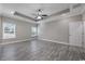 Expansive main bedroom with tray ceiling, ceiling fan, and wood-look flooring at 1107 Haden Place, Calabash, NC 28467