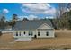 Beautiful new construction home exterior showcasing the back of the house with a nice backyard and deck at 1107 Haden Place, Calabash, NC 28467