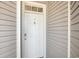 Apartment front door with a security lock and peep hole, set in neutral siding at 1129 Peace Pipe Pl. # 204, Myrtle Beach, SC 29579