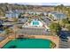 Aerial view of the neighborhood featuring a community pool and a pond with ample parking spaces at 1282 River Oaks Dr. # 9F, Myrtle Beach, SC 29579