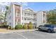 Apartment building with brick archway, balconies, and a gray Honda CRV in the parking lot at 1282 River Oaks Dr. # 9F, Myrtle Beach, SC 29579