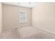 This is an empty carpeted room with neutral walls providing a blank canvas for personalization at 1282 River Oaks Dr. # 9F, Myrtle Beach, SC 29579