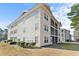 Rear exterior view of a condo building featuring screened porches and vinyl siding at 1282 River Oaks Dr. # 9F, Myrtle Beach, SC 29579