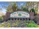 A close view of the 'The Fairways River Oaks' sign surrounded by seasonal flowers and trimmed bushes at 1282 River Oaks Dr. # 9F, Myrtle Beach, SC 29579