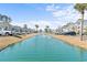 This photo shows a lovely canal running between rows of buildings within the community at 1282 River Oaks Dr. # 9F, Myrtle Beach, SC 29579