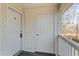 A view of the building's exterior featuring beige siding, two doors and a small porch with a view at 1282 River Oaks Dr. # 9F, Myrtle Beach, SC 29579