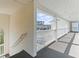 The hallway with a white rail has a neutral color scheme, providing access to the units at 1282 River Oaks Dr. # 9F, Myrtle Beach, SC 29579