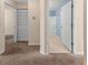 Hallway view with open bathroom door, a closet, and neutral carpeting in the unit at 1282 River Oaks Dr. # 9F, Myrtle Beach, SC 29579