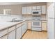 Bright kitchen with white cabinets, appliances, countertops, and wood flooring at 1282 River Oaks Dr. # 9F, Myrtle Beach, SC 29579
