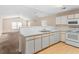 Bright kitchen with white cabinets, appliances, countertops, and wood flooring at 1282 River Oaks Dr. # 9F, Myrtle Beach, SC 29579