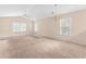 Spacious living room features neutral paint, plush carpet, and natural light at 1282 River Oaks Dr. # 9F, Myrtle Beach, SC 29579