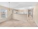 Spacious living room features neutral paint, plush carpet, and natural light at 1282 River Oaks Dr. # 9F, Myrtle Beach, SC 29579