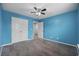 Bedroom offers plush carpeting, a ceiling fan, closet space, and neutral walls, creating a cozy atmosphere at 1320 Midtown Village Dr., Conway, SC 29526