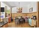 Bright dining area with stylish light fixture, hardwood floors, and seamless flow from living room at 136 Da Gullah Way # A, Pawleys Island, SC 29585