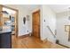 Hallway featuring hardwood floors and light-colored walls, with unique decor and wooden door at 136 Da Gullah Way # A, Pawleys Island, SC 29585