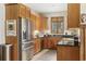 Charming kitchen featuring wood cabinets, granite countertops, and stainless steel appliances at 136 Da Gullah Way # A, Pawleys Island, SC 29585