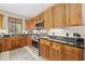 Charming kitchen featuring wood cabinets, granite countertops, and stainless steel appliances at 136 Da Gullah Way # A, Pawleys Island, SC 29585