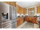 Well-lit kitchen features wooden cabinets, granite countertops, stainless appliances, and tile floors at 136 Da Gullah Way # A, Pawleys Island, SC 29585