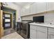 Functional laundry area featuring modern appliances, custom cabinetry, and ample counter space at 136 Da Gullah Way # A, Pawleys Island, SC 29585