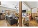 Open-concept living room with hardwood floors, fireplace, and large windows offers plenty of natural light at 136 Da Gullah Way # A, Pawleys Island, SC 29585