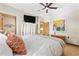 Cozy bedroom with a large bed, ceiling fan, wooden doors, and a television at 136 Da Gullah Way # A, Pawleys Island, SC 29585