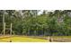 New construction home foundation with yellow barrier on a wooded lot at 1407 Gooseneck Place # 202, Murrells Inlet, SC 29576