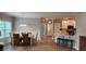Inviting dining area with stylish furniture, wood flooring, and kitchen bar with stools at 1407 Gooseneck Place # 202, Murrells Inlet, SC 29576